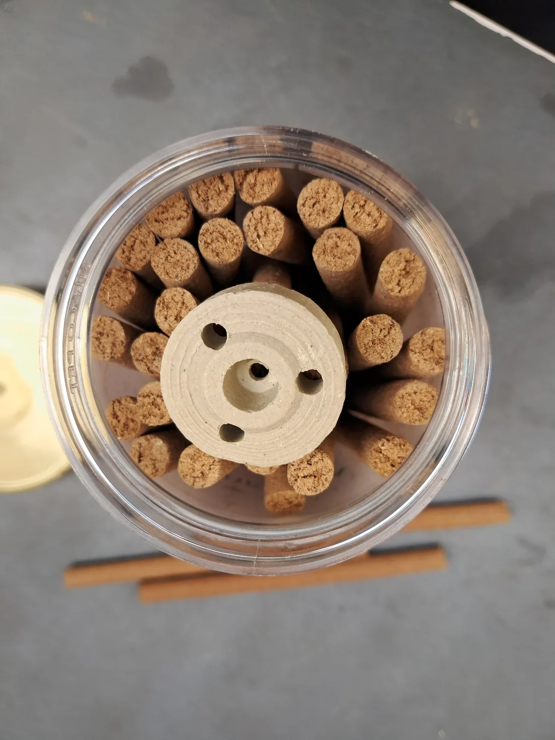 Our actual dhoop sticks and circular holder inside a transparent jar